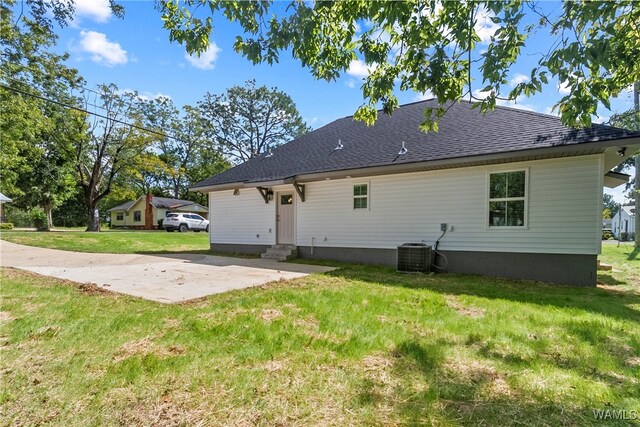 back of property featuring a yard, cooling unit, and a patio area