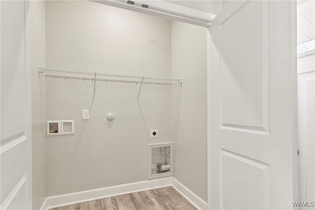 clothes washing area featuring electric dryer hookup, hookup for a washing machine, hookup for a gas dryer, and light hardwood / wood-style flooring