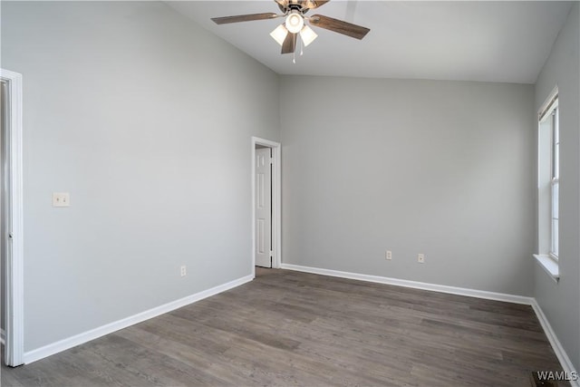 spare room featuring dark wood-style floors, a healthy amount of sunlight, baseboards, and a ceiling fan