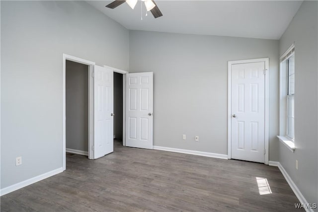 unfurnished bedroom featuring wood finished floors, ceiling fan, baseboards, and lofted ceiling