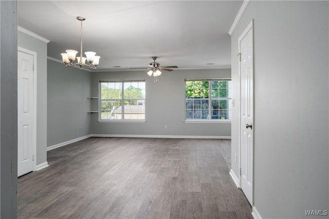 spare room featuring crown molding, wood finished floors, ceiling fan with notable chandelier, and plenty of natural light
