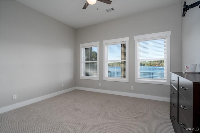 carpeted empty room with ceiling fan