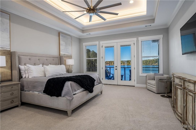 bedroom with french doors, light colored carpet, a tray ceiling, ceiling fan, and access to exterior