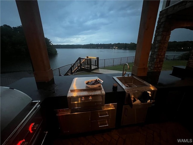 15022 Watercrest Dr, Northport, AL 35475 - view of patio / terrace with exterior kitchen, a water view, a grill, and fence