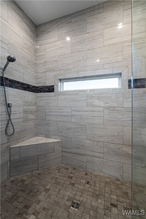 bathroom with tiled shower