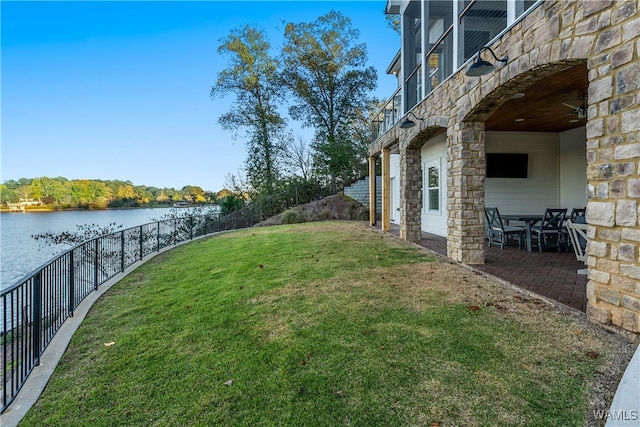 view of yard featuring a patio area and a water view