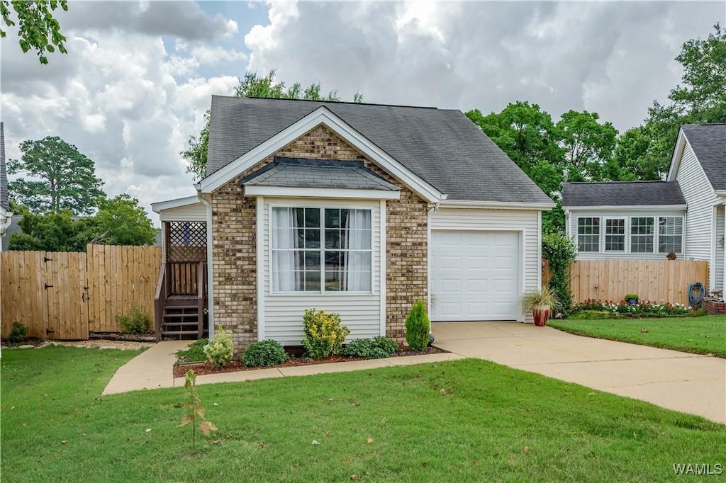 1031 Mockingbird Ln, Northport, AL 35476 - view of front facade with concrete driveway, a garage, roof with shingles, and brick siding