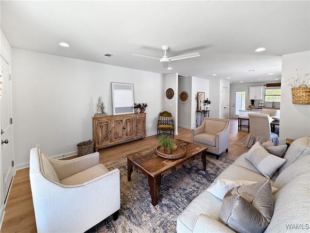 living room featuring hardwood / wood-style flooring and ceiling fan