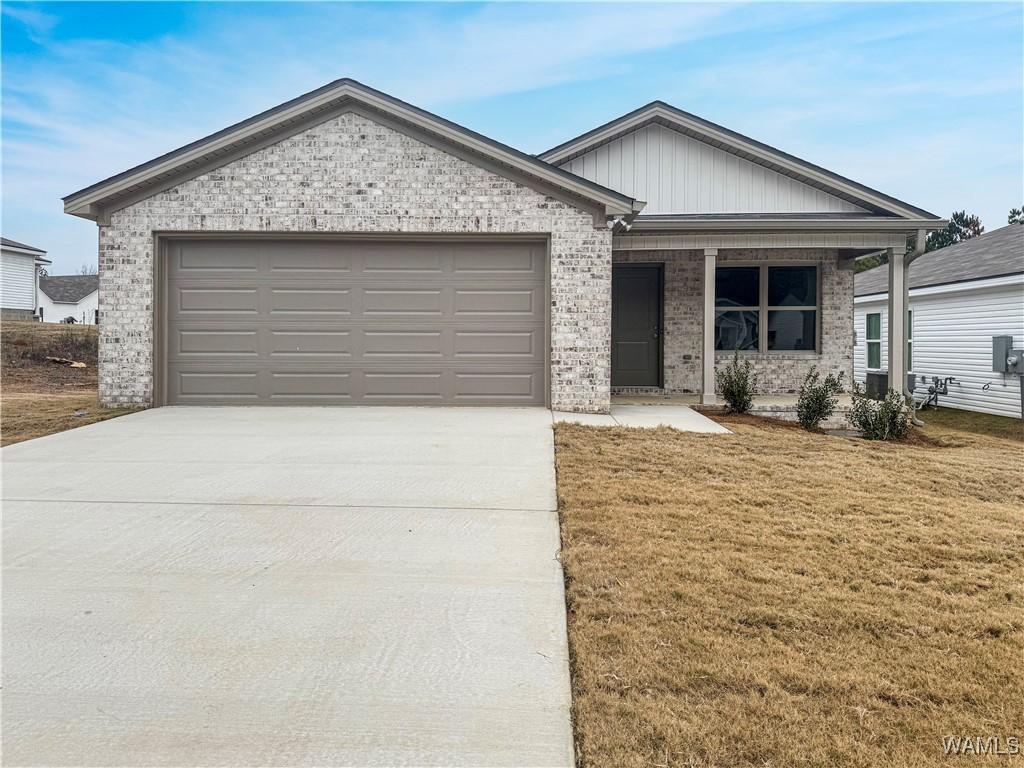 ranch-style house with a garage and a front yard