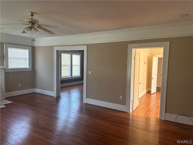 unfurnished room featuring dark hardwood / wood-style flooring, crown molding, ceiling fan, and a healthy amount of sunlight