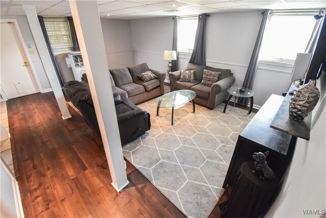 3207 33rd St, Northport, AL 35476 - living area featuring wood finished floors, a paneled ceiling, and baseboards
