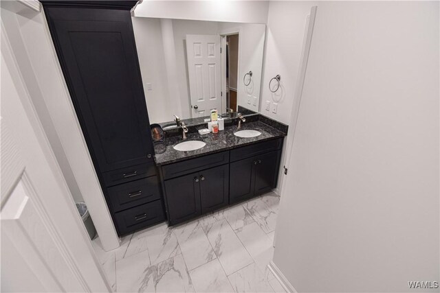 3207 33rd St, Northport, AL 35476 - bathroom featuring baseboards, a sink, double vanity, and marble finish floor