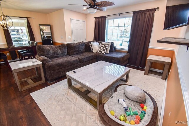 3207 33rd St, Northport, AL 35476 - living room with wood finished floors and ceiling fan with notable chandelier