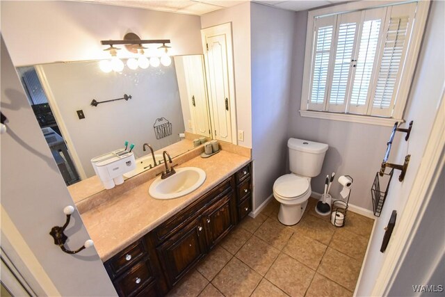 3207 33rd St, Northport, AL 35476 - bathroom with baseboards, toilet, tile patterned flooring, and vanity