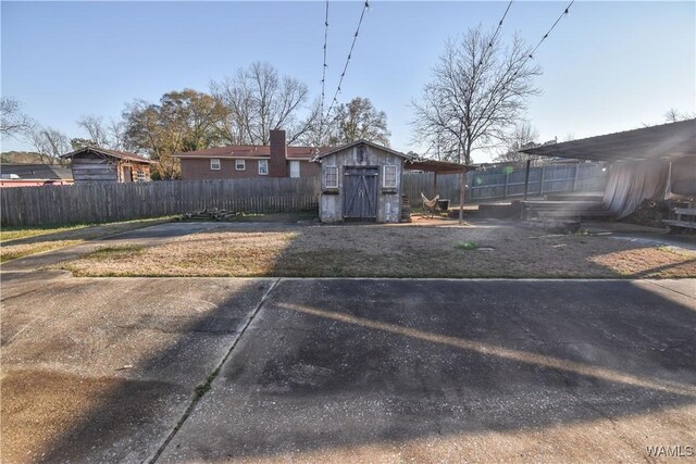 3207 33rd St, Northport, AL 35476 - view of yard featuring a storage unit, fence, and an outbuilding