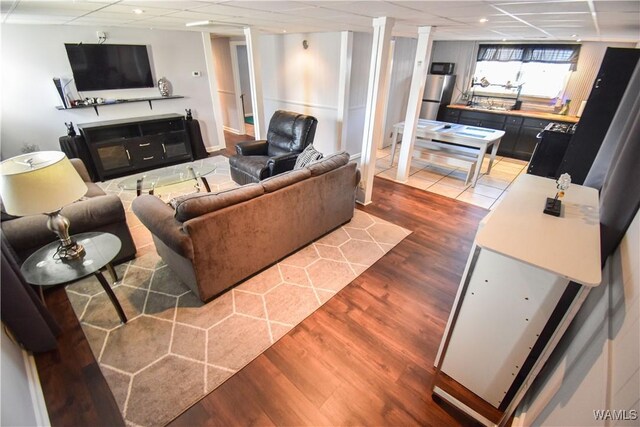 3207 33rd St, Northport, AL 35476 - living room featuring recessed lighting, a drop ceiling, and light wood-style floors