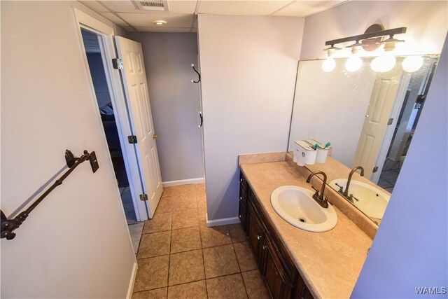 3207 33rd St, Northport, AL 35476 - bathroom with visible vents, baseboards, a drop ceiling, vanity, and tile patterned flooring