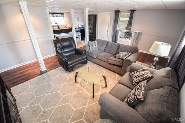 3207 33rd St, Northport, AL 35476 - living room with wood finished floors, baseboards, a drop ceiling, and decorative columns