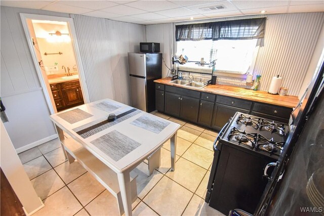 3207 33rd St, Northport, AL 35476 - kitchen with black appliances, light tile patterned floors, a drop ceiling, and a sink
