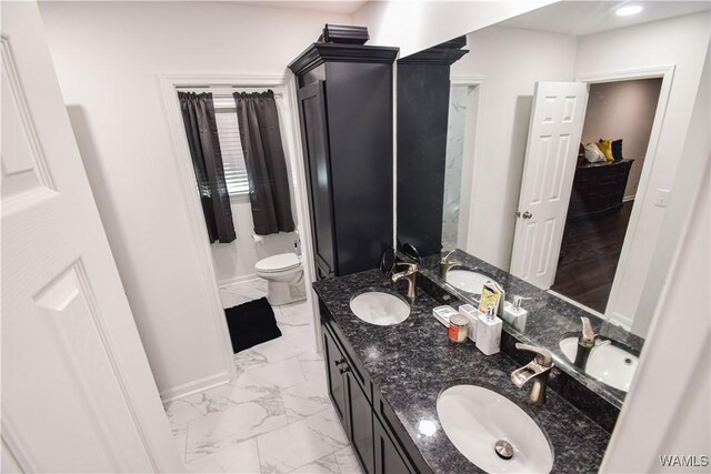 3207 33rd St, Northport, AL 35476 - bathroom with marble finish floor, toilet, and a sink