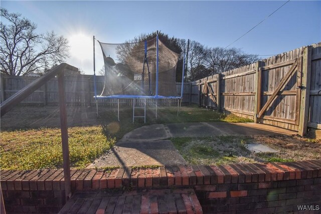 3207 33rd St, Northport, AL 35476 - view of yard with a fenced backyard and a trampoline