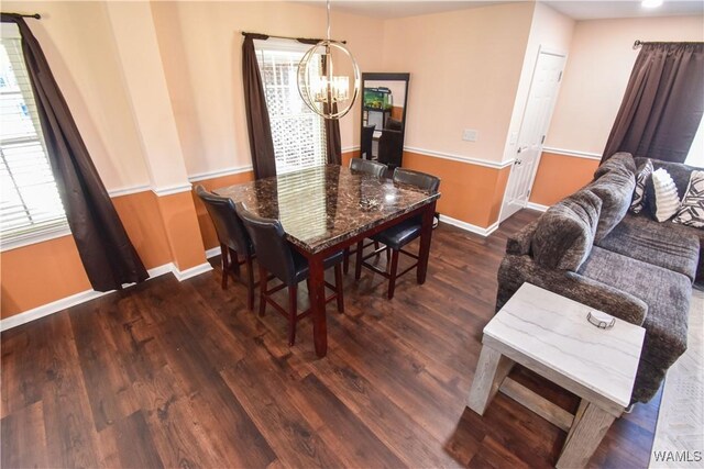 3207 33rd St, Northport, AL 35476 - dining space with an inviting chandelier, wood finished floors, and baseboards