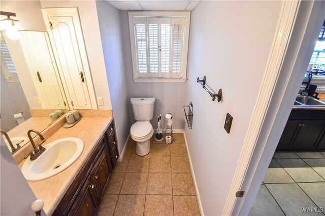 3207 33rd St, Northport, AL 35476 - bathroom with tile patterned floors, toilet, vanity, and baseboards