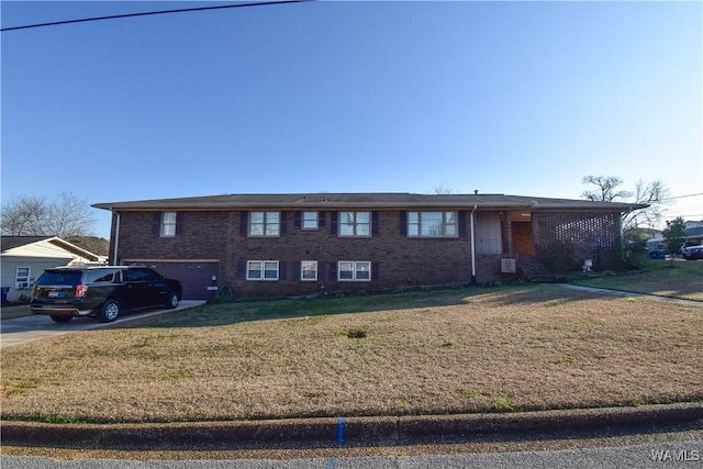 3207 33rd St, Northport, AL 35476 - ranch-style house featuring a front lawn, driveway, an attached garage, and brick siding