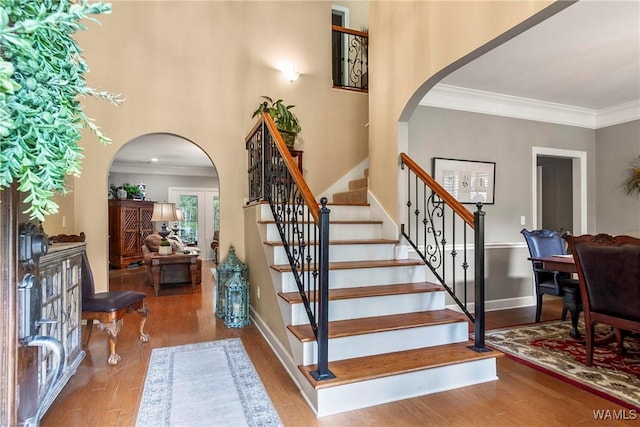 2940 Lake Crest Dr, Tuscaloosa, AL 35406 - stairs with arched walkways, wood finished floors, and ornamental molding