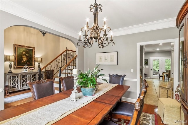 2940 Lake Crest Dr, Tuscaloosa, AL 35406 - dining room with arched walkways, stairway, crown molding, a chandelier, and wood finished floors