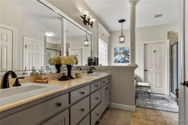 2940 Lake Crest Dr, Tuscaloosa, AL 35406 - full bathroom with a stall shower, double vanity, tile patterned floors, and decorative columns