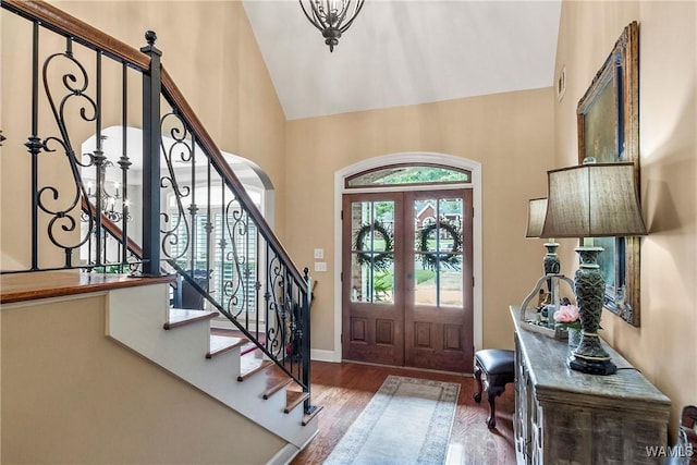 2940 Lake Crest Dr, Tuscaloosa, AL 35406 - entrance foyer with french doors, wood finished floors, stairway, high vaulted ceiling, and arched walkways