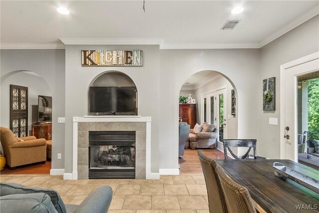 2940 Lake Crest Dr, Tuscaloosa, AL 35406 - tiled living room featuring crown molding, a fireplace, recessed lighting, and arched walkways