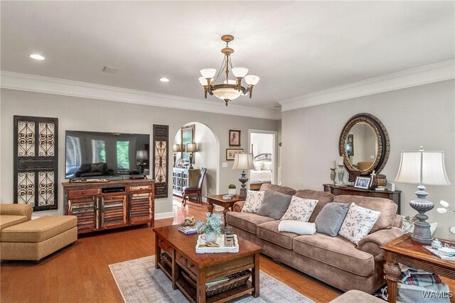 2940 Lake Crest Dr, Tuscaloosa, AL 35406 - living area with arched walkways, ornamental molding, a chandelier, wood finished floors, and recessed lighting