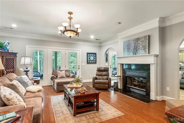 2940 Lake Crest Dr, Tuscaloosa, AL 35406 - living room featuring arched walkways, a fireplace, crown molding, wood finished floors, and recessed lighting