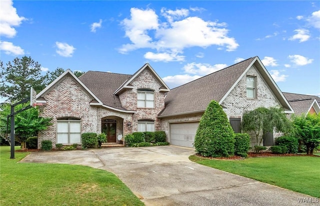 2940 Lake Crest Dr, Tuscaloosa, AL 35406 - french provincial home featuring brick siding, concrete driveway, a front lawn, an attached garage, and a shingled roof