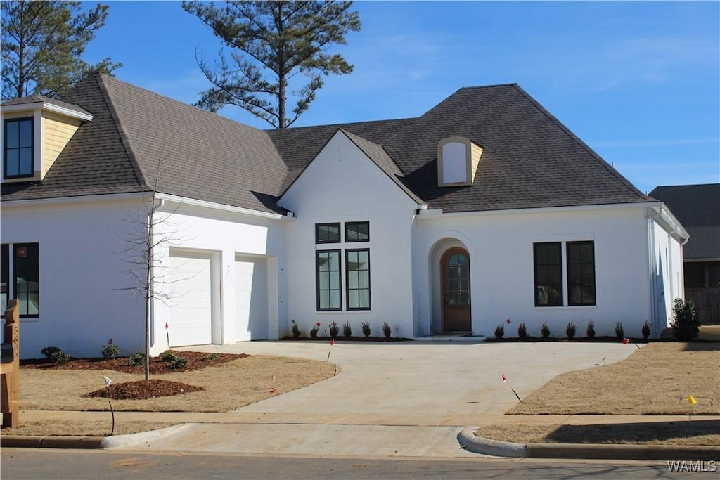 french country inspired facade featuring a garage