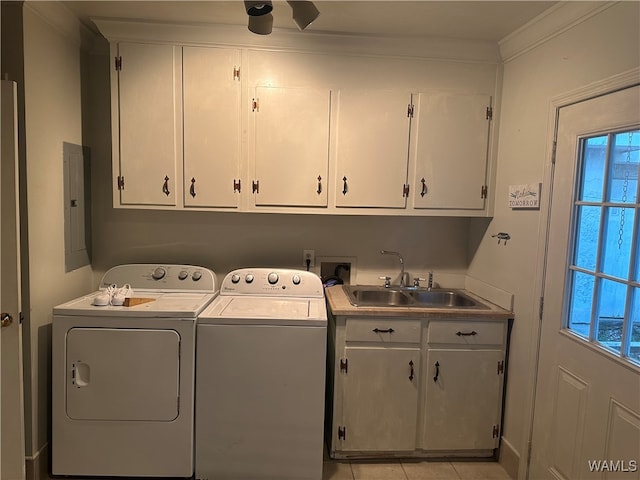 clothes washing area featuring sink, cabinets, electric panel, light tile patterned flooring, and washer and dryer