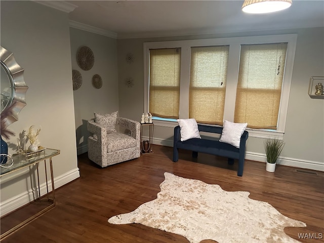 sitting room with dark hardwood / wood-style flooring and ornamental molding