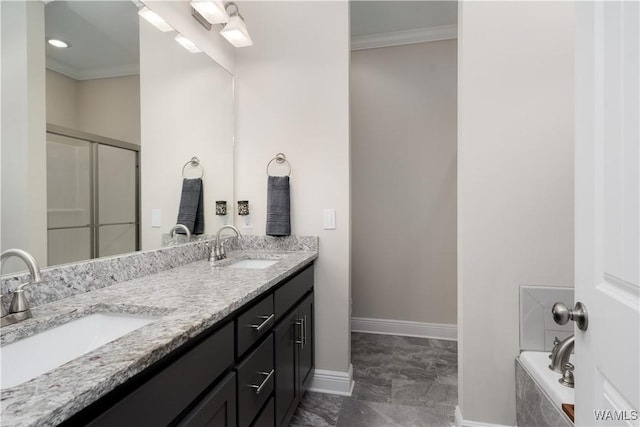 13982 Knoll Pointe Dr, Northport, AL 35475 - bathroom featuring ornamental molding, double vanity, marble finish flooring, a garden tub, and baseboards
