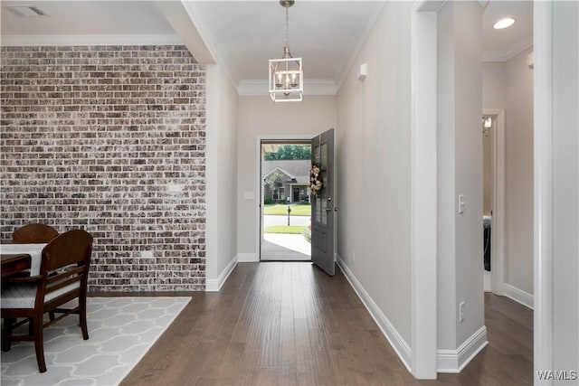 13982 Knoll Pointe Dr, Northport, AL 35475 - entryway featuring wood finished floors, a chandelier, baseboards, crown molding, and brick wall