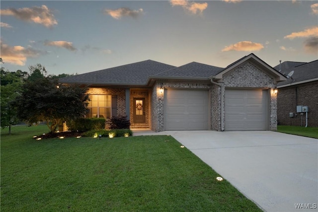 13982 Knoll Pointe Dr, Northport, AL 35475 - view of front of property with an attached garage, driveway, brick siding, a lawn, and roof with shingles