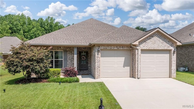 13982 Knoll Pointe Dr, Northport, AL 35475 - view of front of house featuring an attached garage, brick siding, driveway, and a front yard