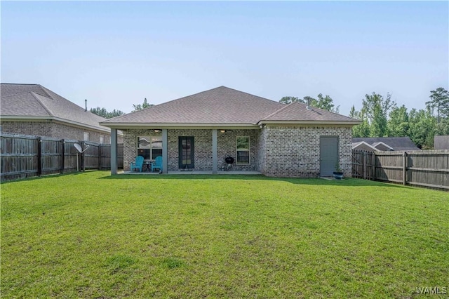 13982 Knoll Pointe Dr, Northport, AL 35475 - back of house with a patio area, a shingled roof, and brick siding