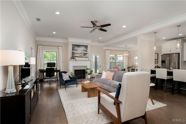 13982 Knoll Pointe Dr, Northport, AL 35475 - living room featuring a high end fireplace, dark wood-type flooring, recessed lighting, a ceiling fan, and a chandelier