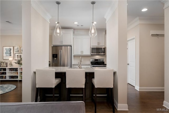 13982 Knoll Pointe Dr, Northport, AL 35475 - kitchen with appliances with stainless steel finishes, a peninsula, ornamental molding, dark wood-style floors, and a kitchen breakfast bar