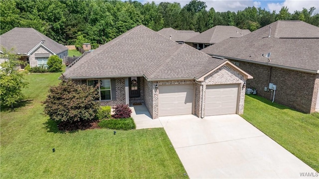 13982 Knoll Pointe Dr, Northport, AL 35475 - view of front of home featuring brick siding, an attached garage, concrete driveway, and a front yard