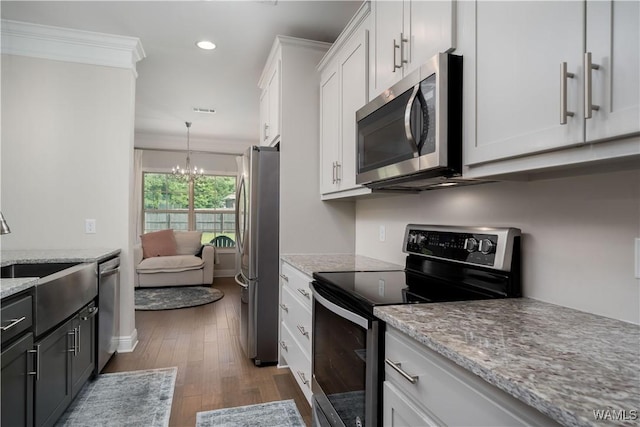 13982 Knoll Pointe Dr, Northport, AL 35475 - kitchen with appliances with stainless steel finishes, a sink, white cabinetry, recessed lighting, and a chandelier