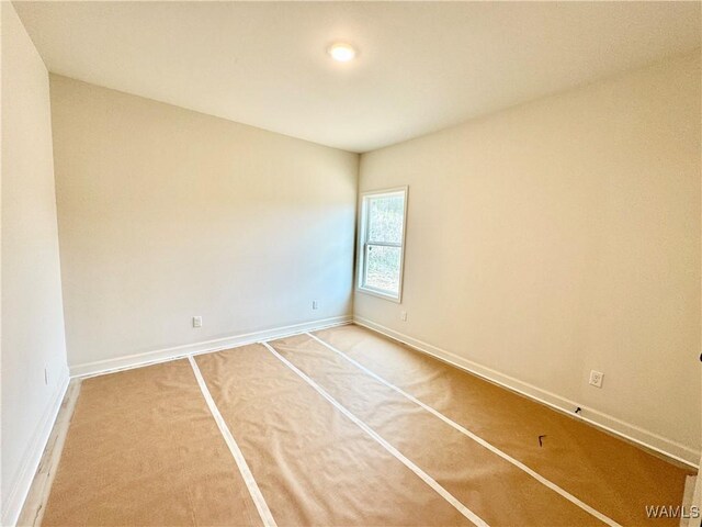 empty room featuring wood-type flooring