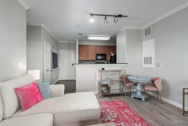 600 13th St E Unit 735, Tuscaloosa, AL 35401 - living area with wood finished floors, baseboards, and ornamental molding